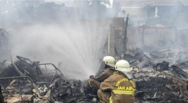 Petugas pemadam kebakaran sedang memadamkan kebakaran di rumah warga di Simpruk Permata Hijau. (Ist)
