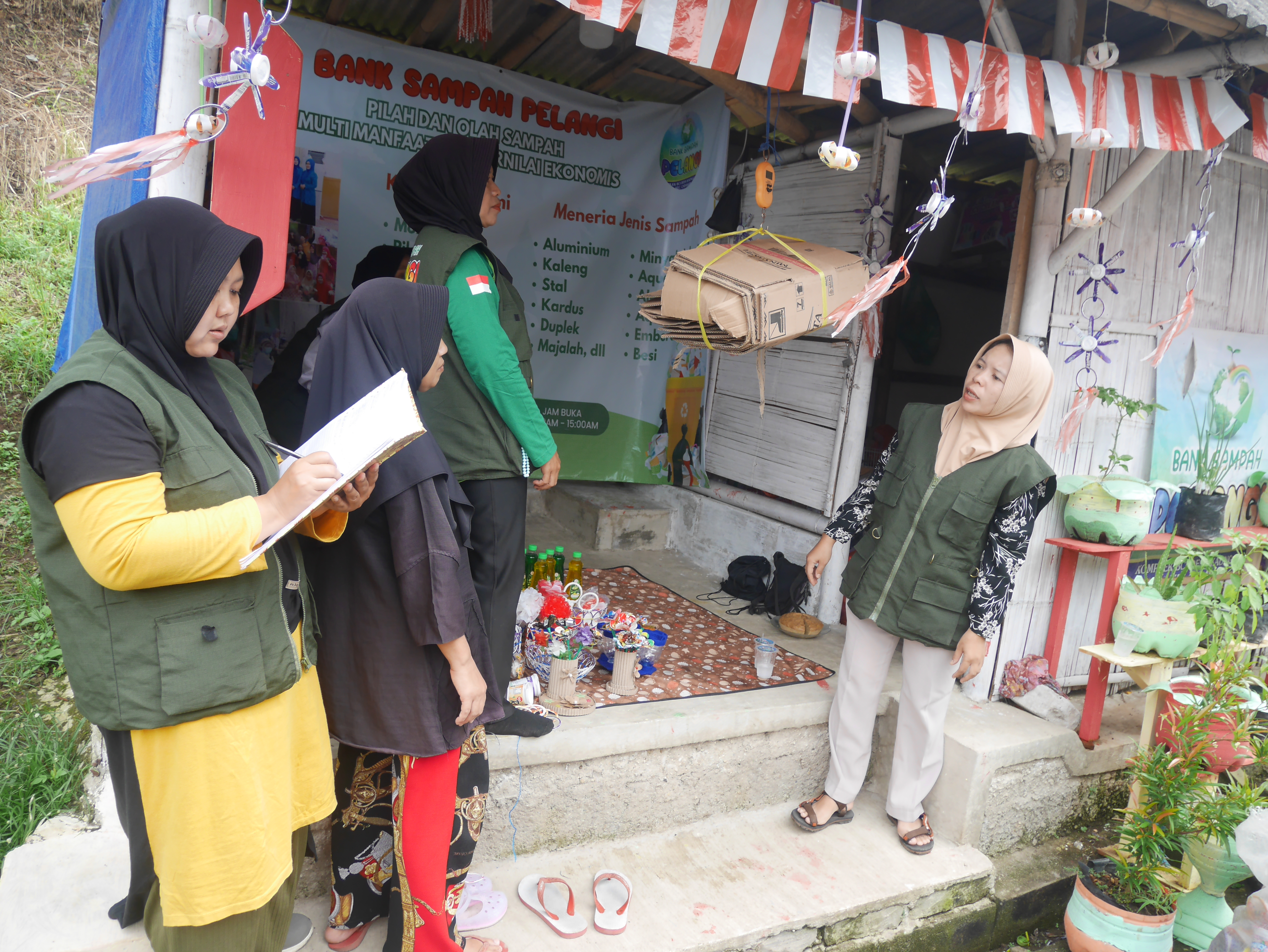 Pengurus Bank Sampah Pelangi di Perumahan BCI, Cadasari, Kabupaten Pandeglang, Jumat (8/8/2025) tengah menimbang sampah kiriman warga.(Ari Supriadi/tangselpos.id)