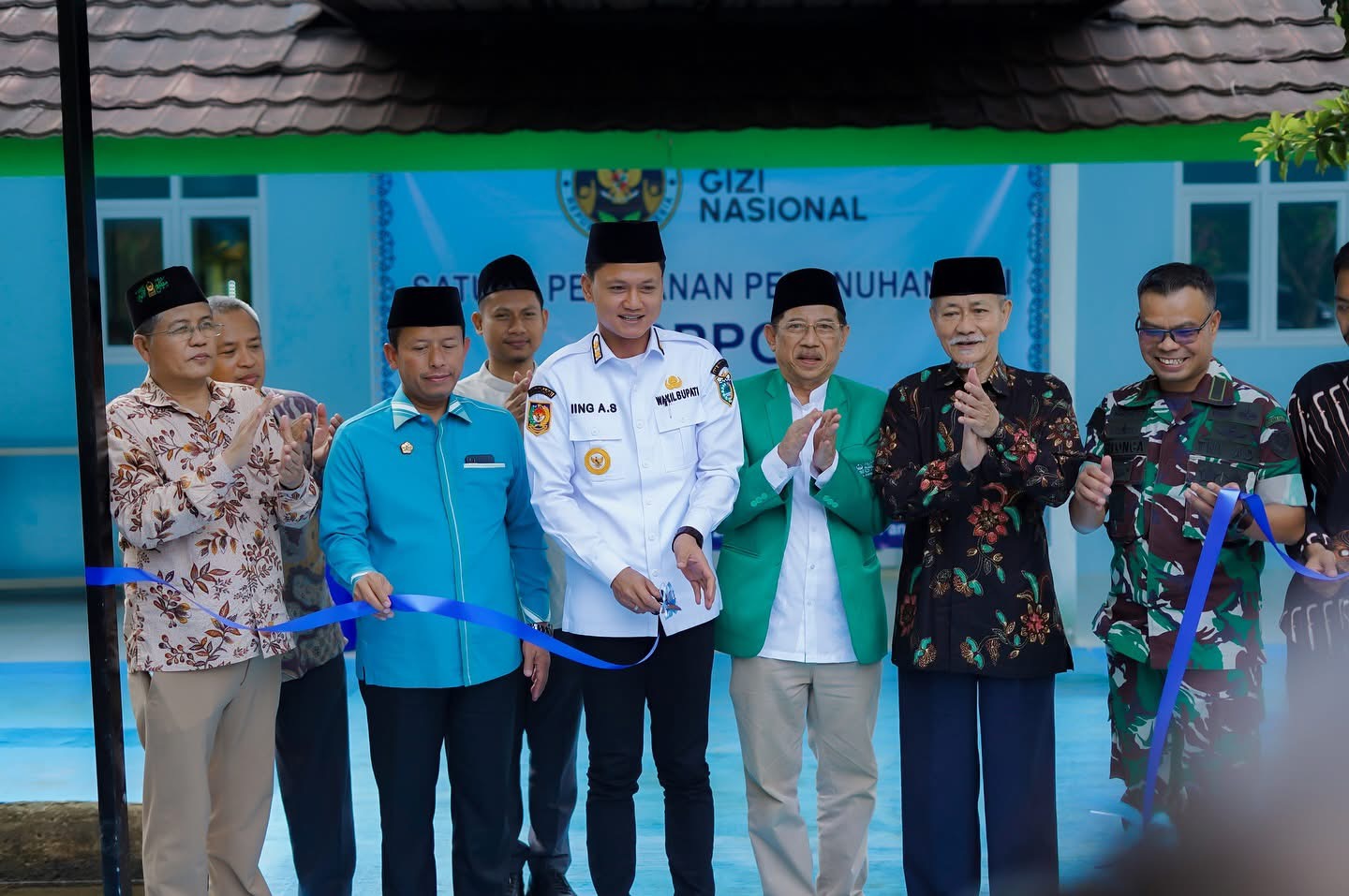 Wabup Pandeglang Iing Andri Supriadi didampingi jajarannya, pengurus Mathla'ul Anwar Pusat dan lainnya, secara simbolis menggunting pita yang menandakan meresmikan SPPG di Perguruan Mathla'ul Anwar Pusat Menes, Sabtu (11/10).