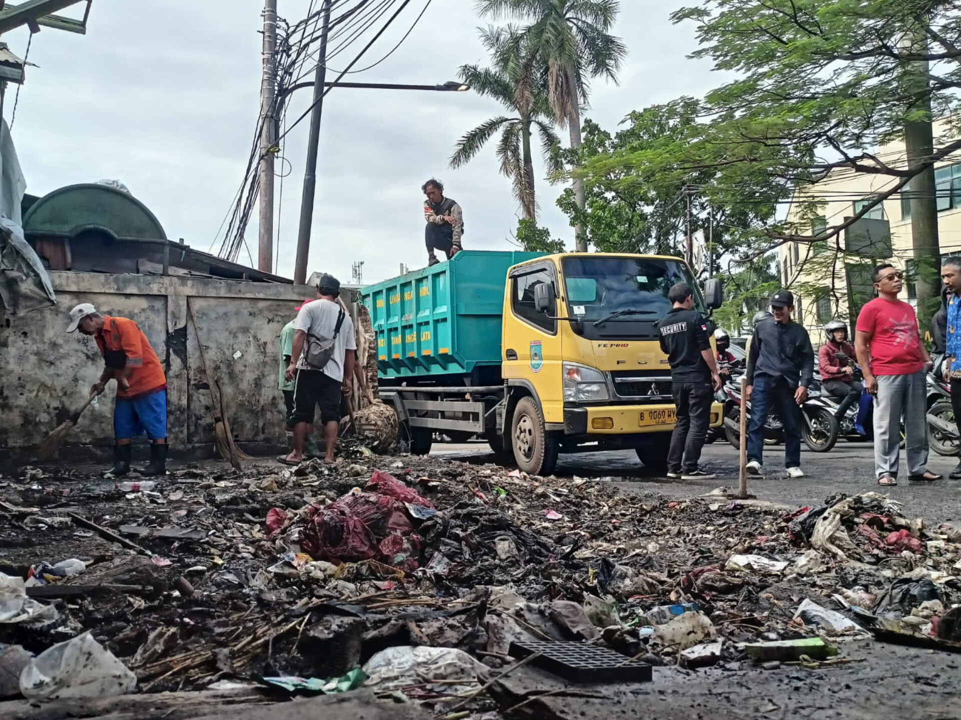 Petugas kebersihan  memindahkan sisa-sisa sampah secara manual ke dalam truk. (tangselpos.id/rmn)