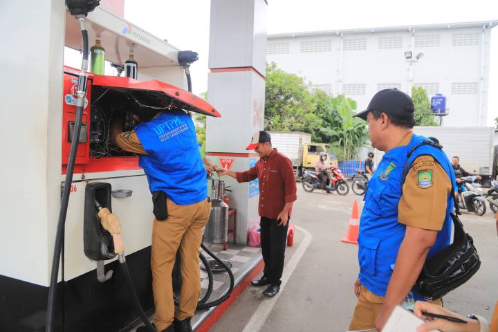 Petugas UPT Pelayanan Metrologi Legal Dinas Perindustrian Perdagangan Koperasi dan UKM (Disperindagkop UKM) Kota Tangerang melakukan pemeriksaan dan pengujian alat ukur di SPBU 34.15128 Jatiuwung, Kota Tangerang, Selasa (27/1).
