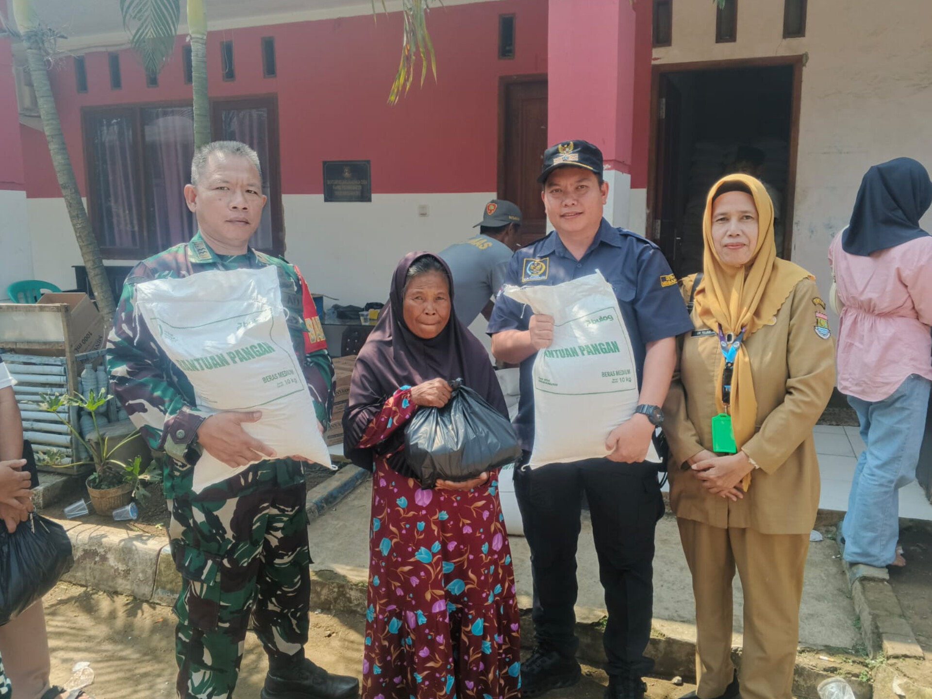 Kepala Desa Dangdang bersama Babinsa, Bhabinkamtibmas, dan perangkat desa menyerahkan bantuan pangan kepada warga di Kantor Desa Dangdang, Cisauk, Selasa (2/6/2026). (Andi AE)