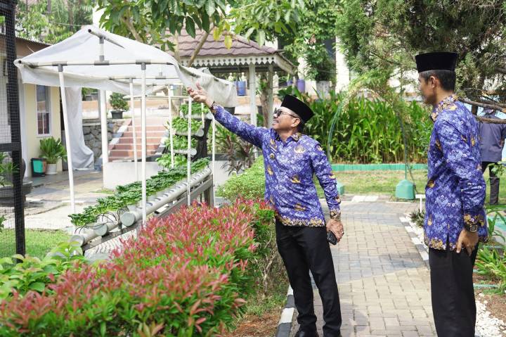 MERAPIKAN TANAMAN.  Wali Kota Tangerang, Sachrudin, merapikan tanaman saat kegiatan monitoring dan pembinaan kewilayahan di Kecamatan Karawaci, Senin (19/10).
