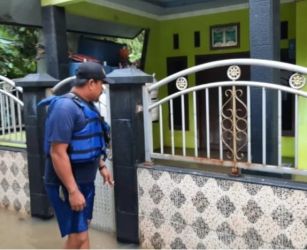 Petugas BPBD Kabupaten Tangerang sedang memantau rumah warga yang terendam banjir. (Ist)