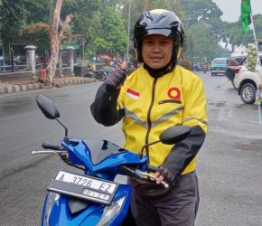 Seorang driver Maxim berpose di atas sepeda motornya di Alun-alun Pandeglang, Selasa (14/11/2023).(Istimewa)