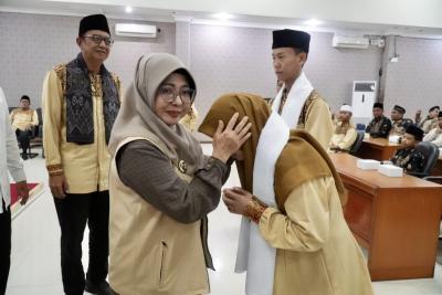 PAKAIKAN SORBAN. Bupati Pandeglang Raden Dewi Setiani, secara simbolis memakaikan sorban kepada perwakilan kafilah, sebelum diberangkatkan untuk mengikuti lomba MTQ Provinsi Banten, di Oproom Setda Pandeglang, Minggu (5/7). (DOK. PROKOPIM SETDA PANDEGLANG)